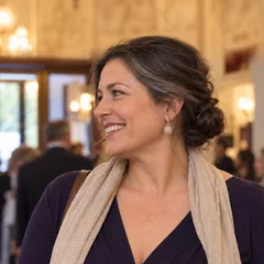 Rachel Morgan, a ballet teacher with dark hair in a low bun, smiling in a theatre foyer